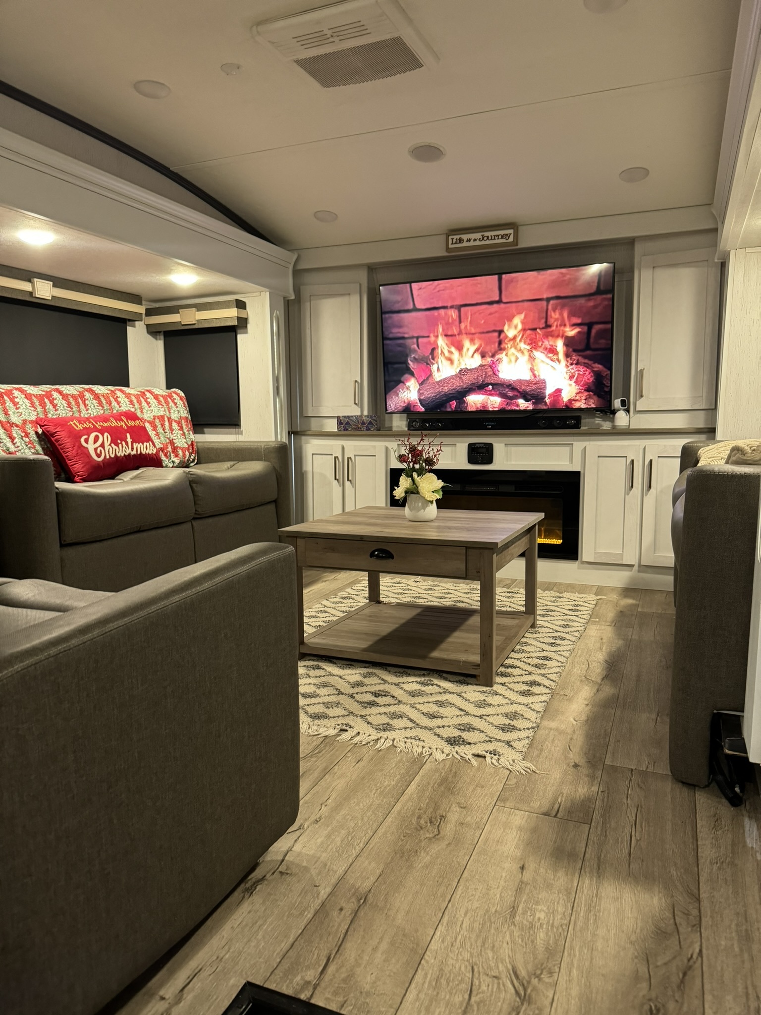 Comfortable RV living room with television and fireplace